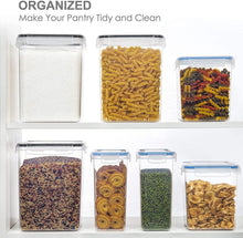 Set of clear pantry storage canisters with matching lids, filled with mixed dry foods
