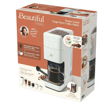 Single-serve coffee maker retail box in white and orange with machine photo