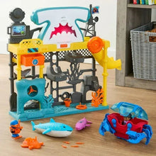 Ocean adventure playset with shark station structure and toy submarines on the floor