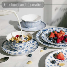 Blue-and-white ceramic bowls and plates with fruit, strawberries on dish set