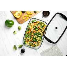 Glass baking dish with lid, filled with mixed vegetables and black rim