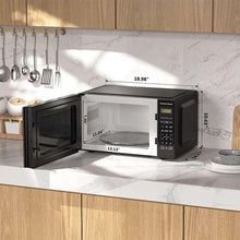 Countertop microwave oven with open door showing glass turntable and control keypad
