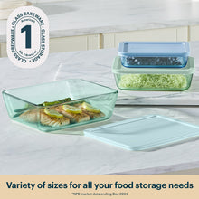 Tinted rectangular plastic storage containers with blue and green lids, set of three