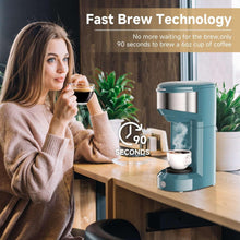 Teal single-serve coffee maker dispensing steaming coffee into a white mug