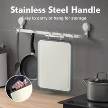 Double-sided cutting board with stainless handle, hanging for storage.