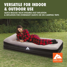 Twin air mattress on outdoor grass, gray top and dark base with quilted air cells