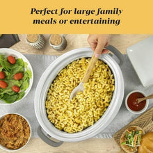 Grey oval slow cooker pot with pasta inside and serving utensil