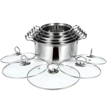 Stainless steel pot set with nested stockpots and glass lids arranged in a circle