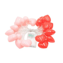 Heart-shaped string lights set with red and pale pink heart bulbs on wire
