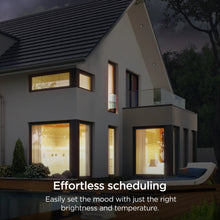 Smart LED bulbs illuminating a house exterior windows with warm light