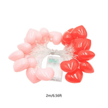 Heart-shaped string lights set with red and pale pink heart bulbs and wire