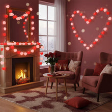 Heart-shaped string lights forming large heart outline, glowing red lights