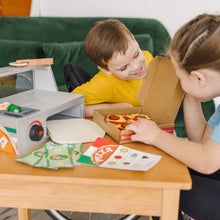 Wooden pizza counter play set on tabletop with pizza pieces and instruction cards