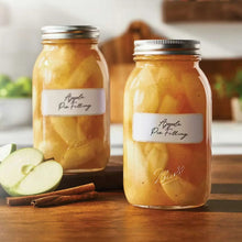 Glass mason jar with metal lid, filled with apple preserves