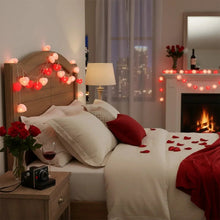 Heart-shaped string lights draped over bed and window, glowing red hearts
