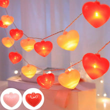 Heart-shaped string lights with glowing red and pink hearts on hanging strand