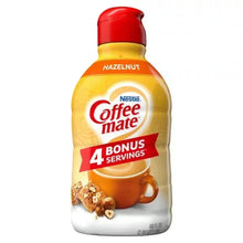 Liquid coffee creamer bottle with hazelnut flavor, red cap and yellow label