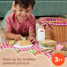 Woven picnic basket with checkered liner and wooden play food on table