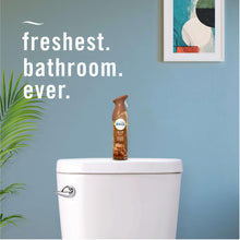 Brown Febreze Air Mist aerosol spray bottle standing on a toilet tank