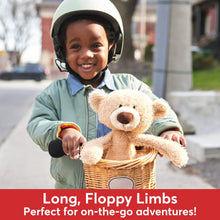 Beige teddy bear plush with long floppy limbs and brown nose in a basket