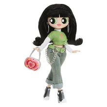Doll standing in green top and gray jeans with belt, chain, and pink heart bag.
