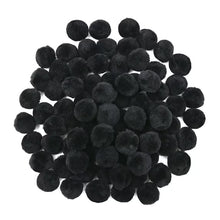 Pile of black fuzzy craft pom poms