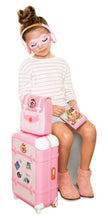 Pink child suitcase playset with accessory kit, eye mask and travel items