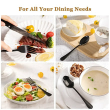 Stainless steel cutlery with black handles in use: knives, forks, and spoons