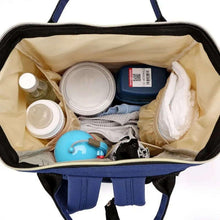 Black diaper backpack with open interior, showing bottle and wipes storage pockets