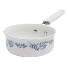 White ceramic skillet with blue floral print and white handle
