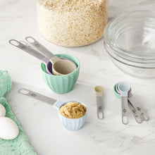 Plastic measuring cup and spoon set with pastel scoops and metal handles
