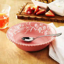 Pink floral melamine serving bowl with spoon, white daisy-style print