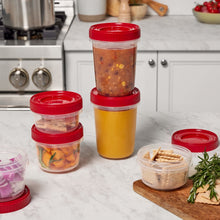 Stacked red-lidded food storage containers with clear sides and one yellow container