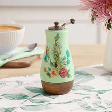 Ceramic pepper mill with floral mint body, metal grinder top, acacia wood base