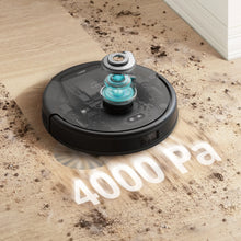 Black robot vacuum on wood floor with teal suction airflow, showing 4000 Pa