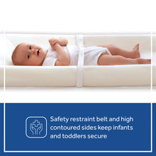 White contoured changing pad with high sides and a safety restraint belt