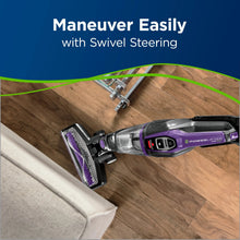 Purple and gray cordless stick vacuum with swiveling head on wood flooring
