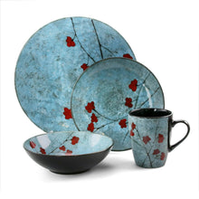 Blue dinnerware set featuring plates and mugs with red floral branches