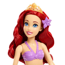 Mermaid doll with red wavy hair, purple seashell top, and blue eyes