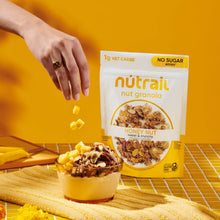 nutrail Honey Nut granola pouch with bowl of granola and scattered pieces
