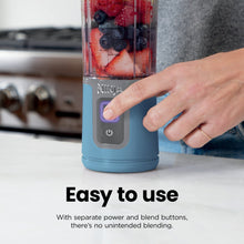 Blue portable personal blender base with control buttons and clear cup
