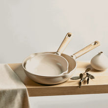 Taupe ceramic skillet with matching lid and long wooden-style handle