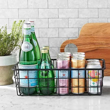Two-tier fruit basket stand with black wire baskets and bamboo handle, holding bottles and jars