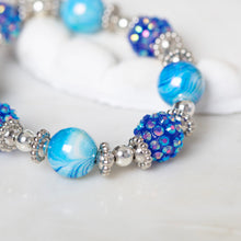 Blue and purple beaded bracelet with round glass beads and silver-tone spacer beads