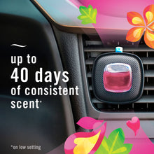 Febreze Car vent clip air freshener attached to a vent, with a pink scent reservoir