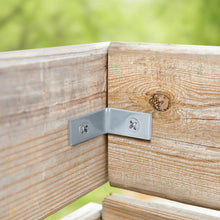 Zinc-plated corner brace with screws fastened at a wood corner.