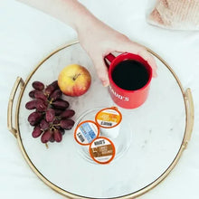 Coffee pods variety pack cups and brewed coffee in red mug with pod lids