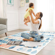 Diaper changing kit with changing pad laid out and wipes case folded beside pad