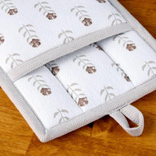 Square pot holder with white fabric, floral print, and gray border trim