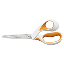 Side view of white and orange fabric scissors with loop handles